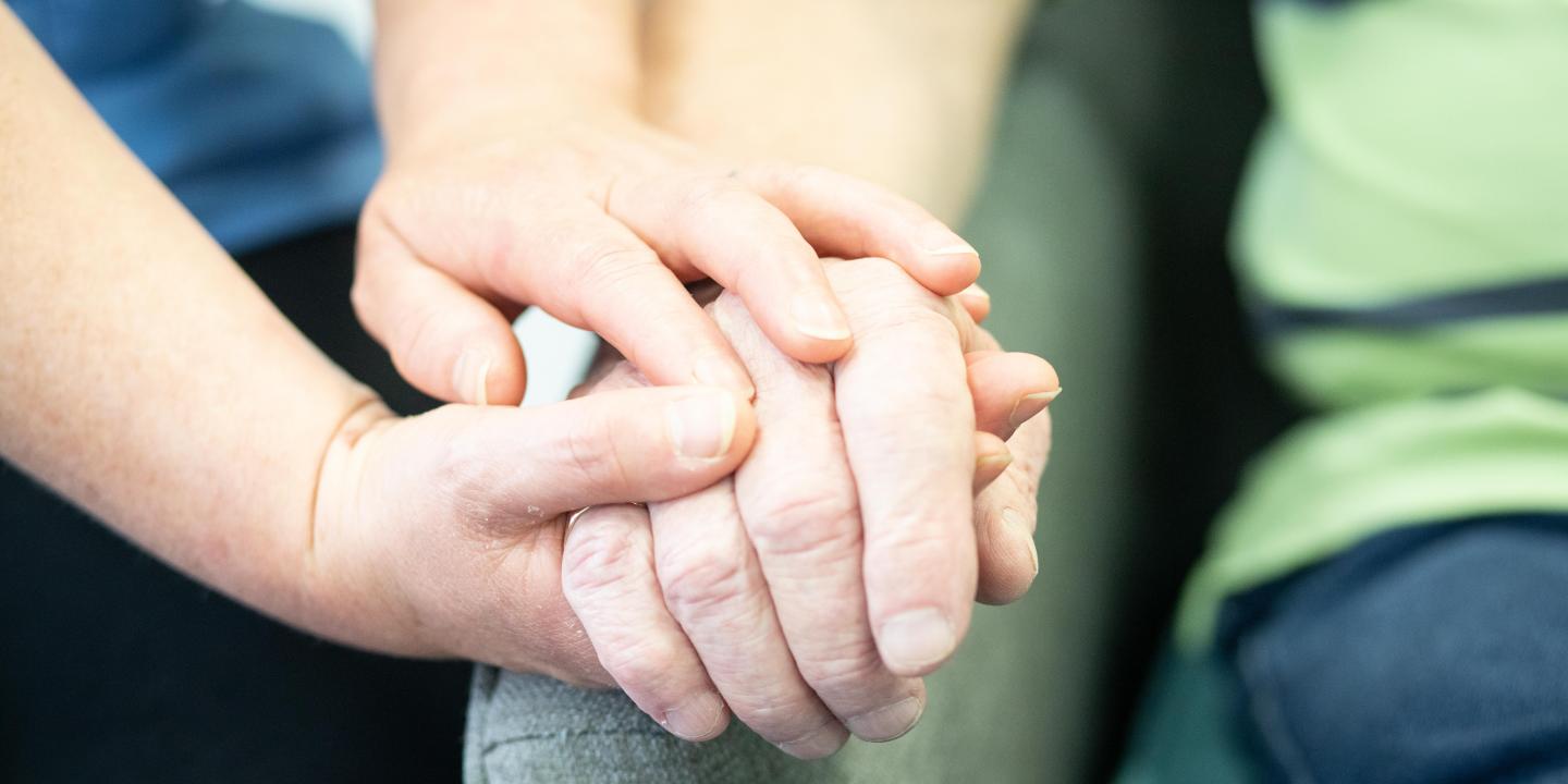 carer holding hands