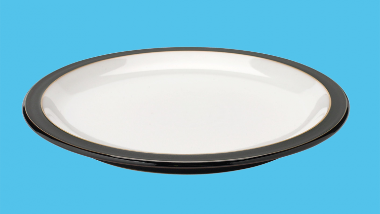 A dinner plate with a contrasting edge and slightly raised lip