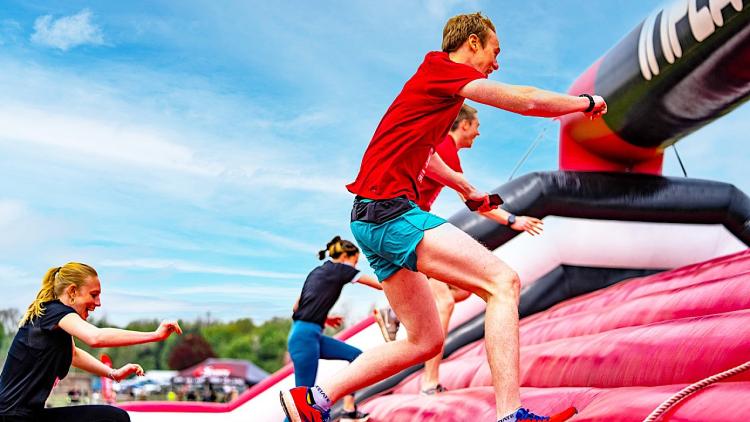 A person going uphill on an inflatable obstacle