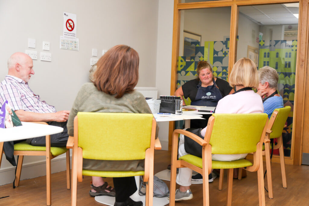 Several people sat around a table at Alzheimer Scotland dementia resource centre