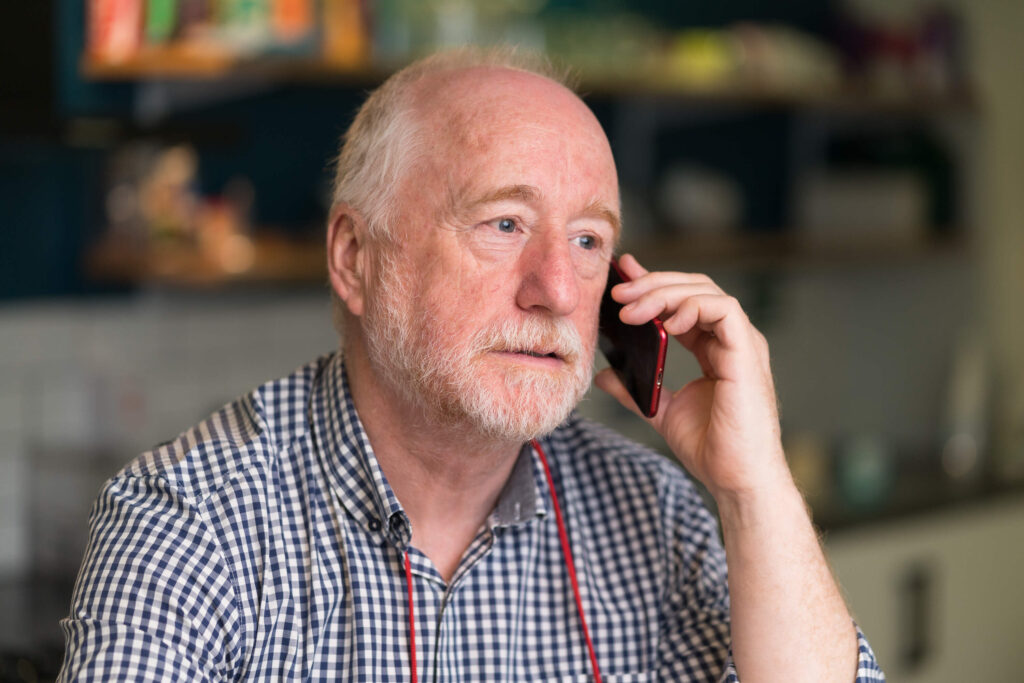 A man answering a call to the Alzheimer Scotland Freephone Helpline